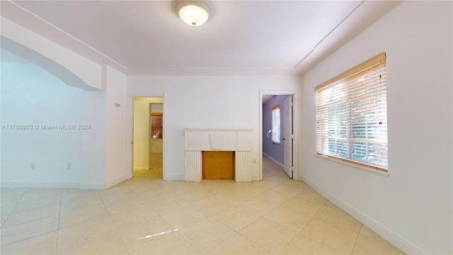 unfurnished room featuring light tile patterned floors