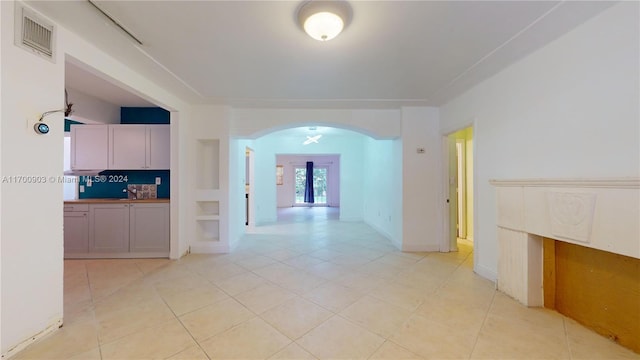 hall featuring light tile patterned floors and french doors