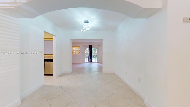 hall with french doors and light tile patterned floors