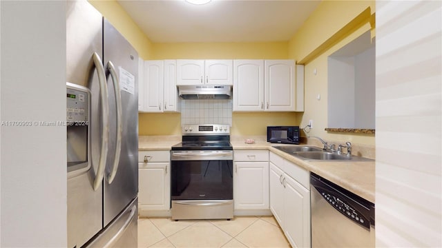 kitchen with tasteful backsplash, stainless steel appliances, sink, white cabinets, and light tile patterned flooring