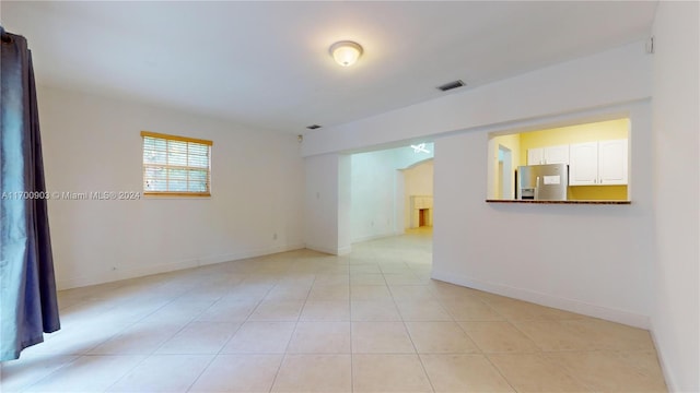 spare room featuring light tile patterned floors