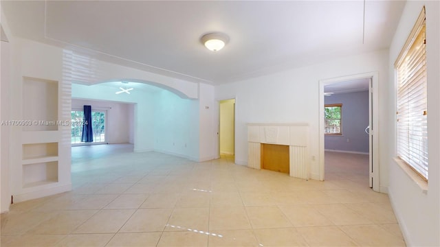 tiled empty room with french doors and built in features