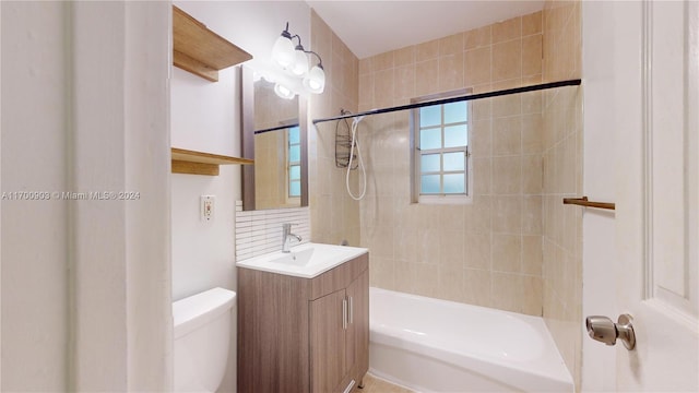 full bathroom featuring toilet, vanity, and tiled shower / bath