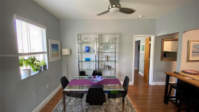 dining area featuring wood-type flooring and ceiling fan