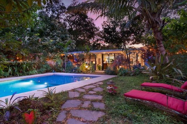 view of pool at dusk