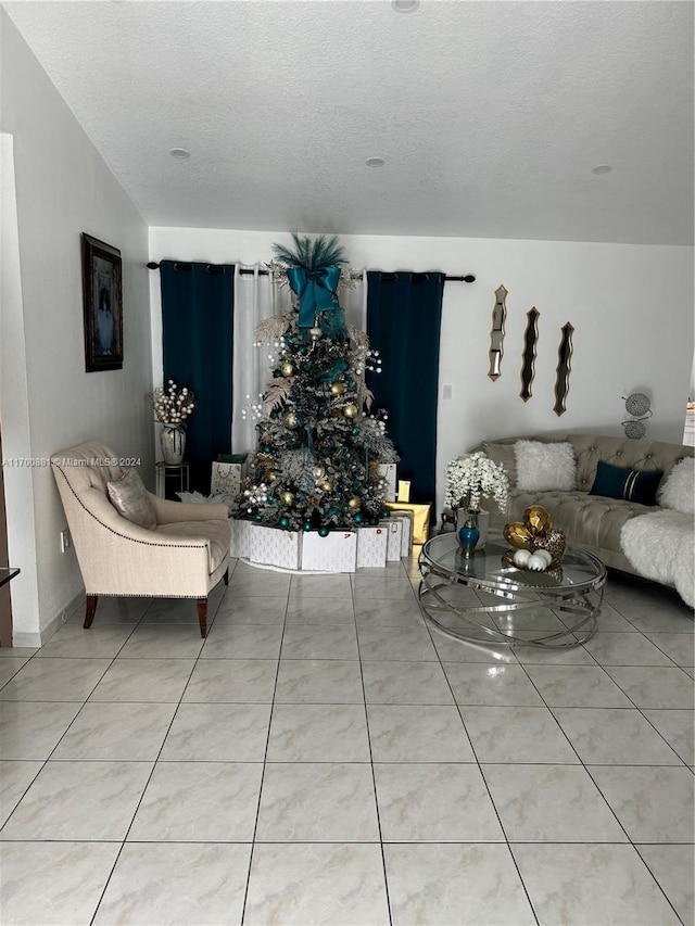 living room with tile patterned flooring and a textured ceiling