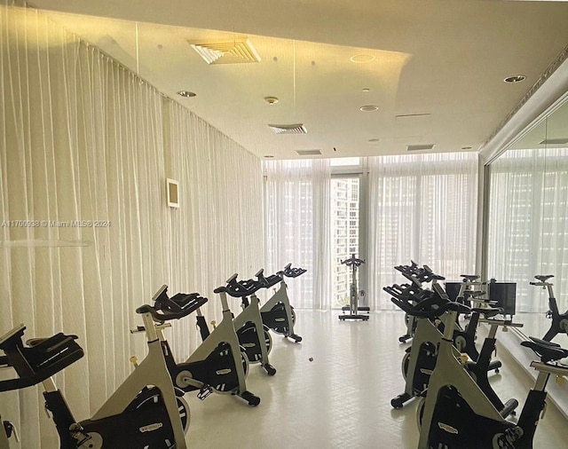 workout area with a wall of windows and wooden walls