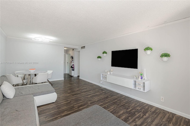 unfurnished living room featuring a textured ceiling, dark hardwood / wood-style floors, and ornamental molding