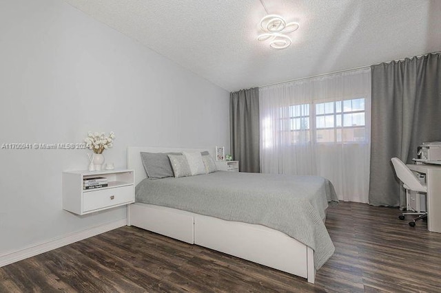 bedroom featuring dark hardwood / wood-style floors and a textured ceiling