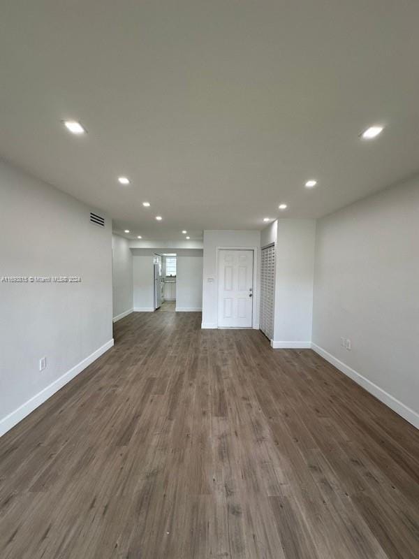 unfurnished living room with dark hardwood / wood-style flooring