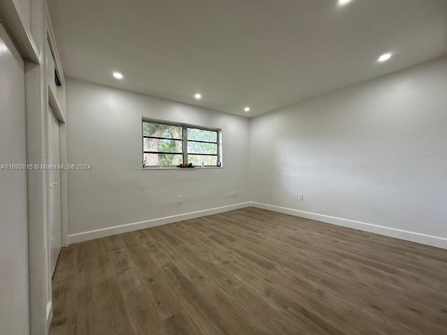 unfurnished bedroom featuring dark hardwood / wood-style flooring