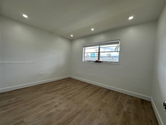 spare room with hardwood / wood-style flooring