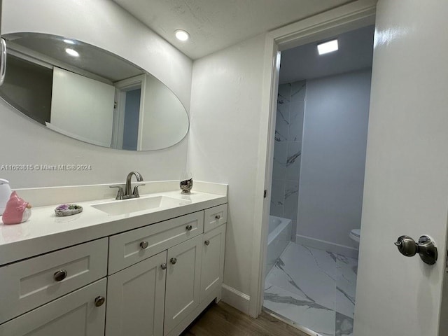 full bathroom with vanity, hardwood / wood-style flooring, toilet, and tub / shower combination