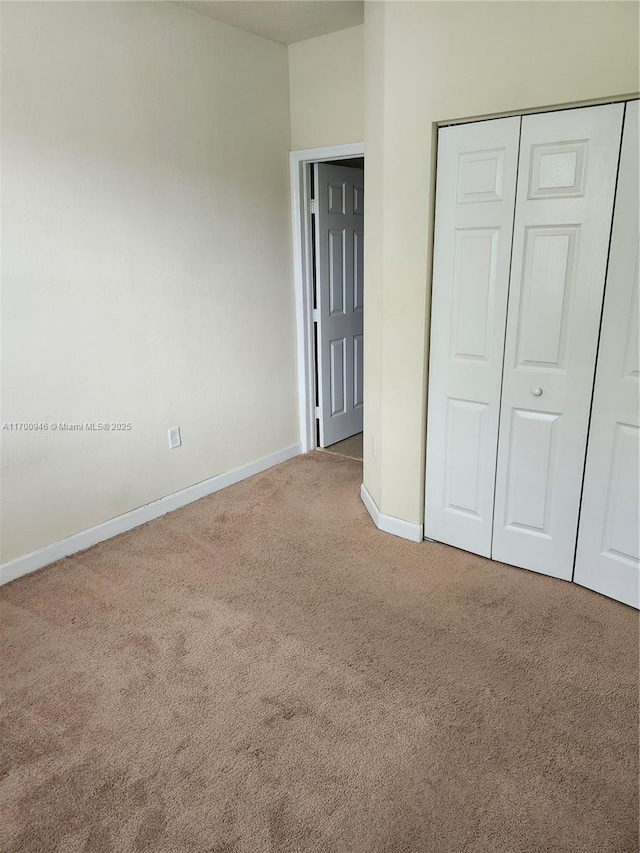 unfurnished bedroom featuring a closet and carpet floors