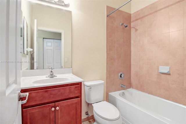 full bathroom with tiled shower / bath combo, vanity, and toilet