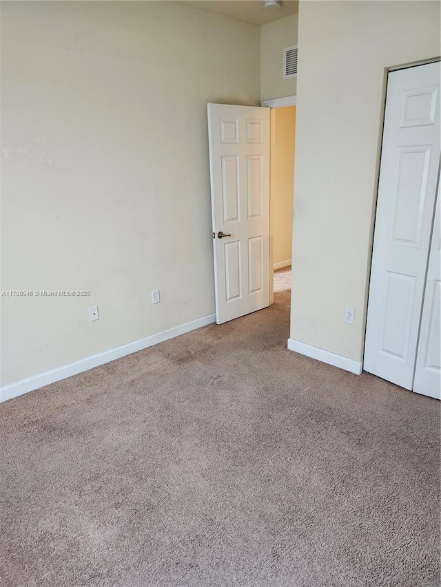 empty room featuring carpet flooring