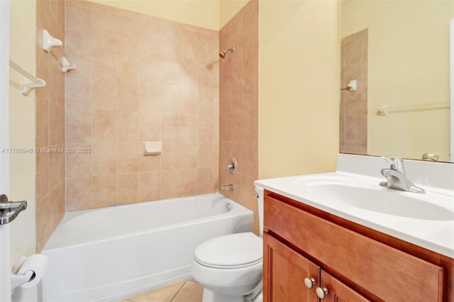 full bathroom with tiled shower / bath, vanity, toilet, and tile patterned floors