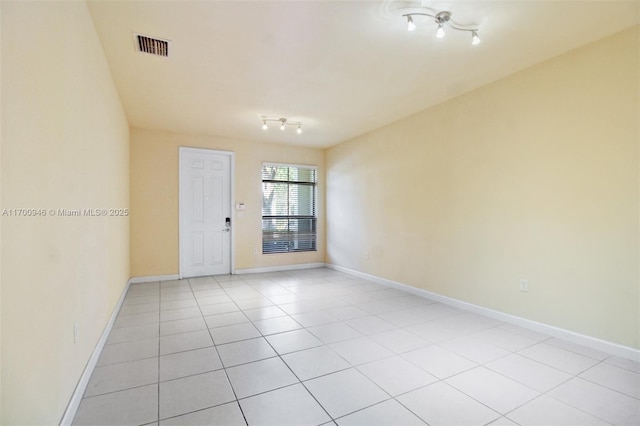 spare room featuring light tile patterned flooring