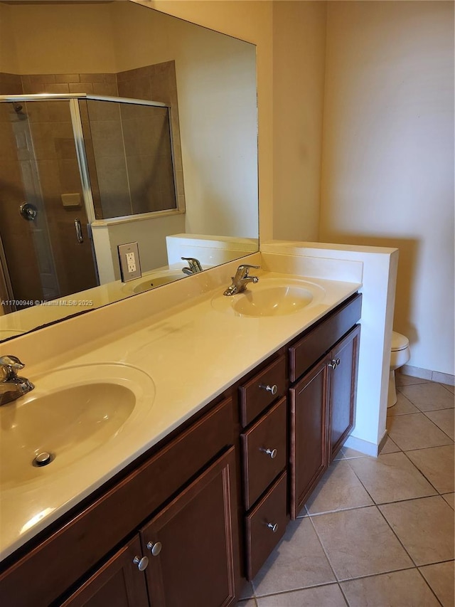 bathroom featuring toilet, walk in shower, tile patterned floors, and vanity