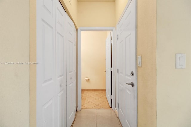 hallway featuring light tile patterned floors