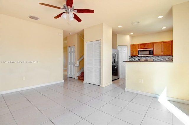 interior space with ceiling fan