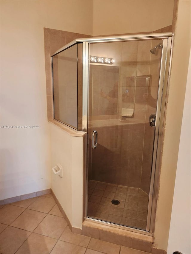 bathroom featuring tile patterned floors and a shower with door