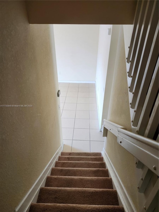 staircase featuring tile patterned floors