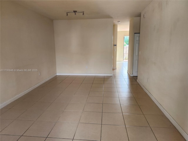 tiled empty room with track lighting