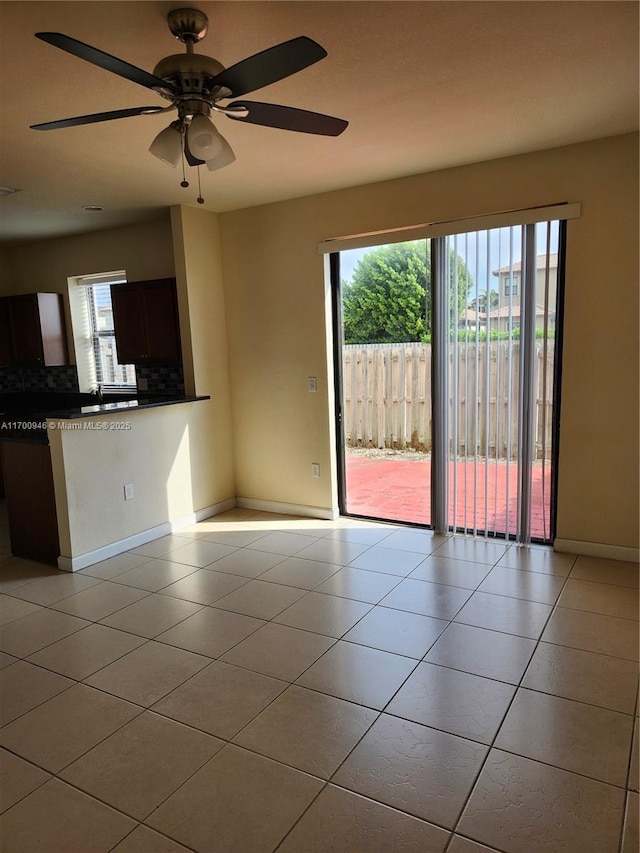 unfurnished living room featuring ceiling fan and light tile patterned floors