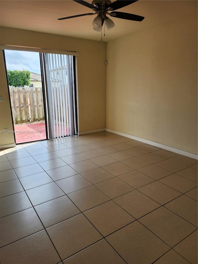 tiled empty room featuring ceiling fan