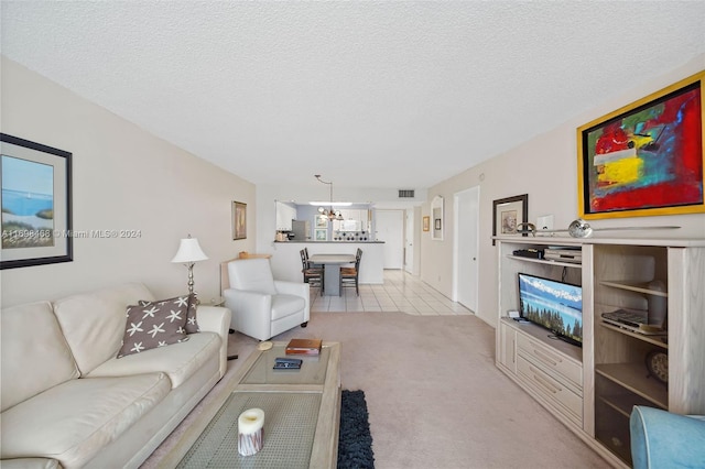 living room featuring light carpet and a textured ceiling