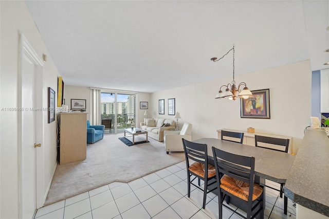 dining area with light carpet and a notable chandelier