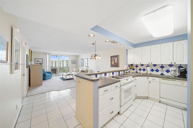 kitchen with white cabinetry, hanging light fixtures, kitchen peninsula, light colored carpet, and white appliances