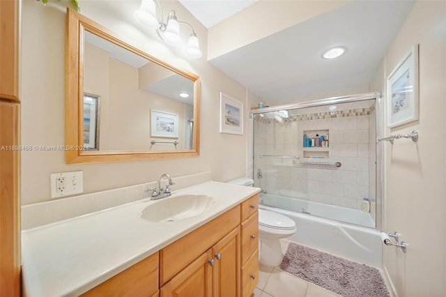 full bathroom featuring tile patterned flooring, vanity, toilet, and enclosed tub / shower combo