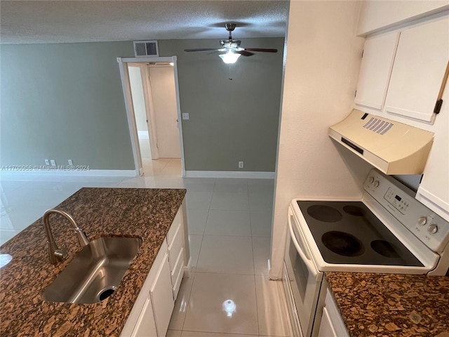 kitchen with white cabinets, a textured ceiling, white range oven, and sink