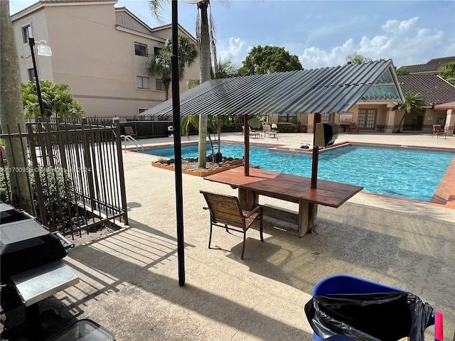 view of swimming pool with a grill and a patio area