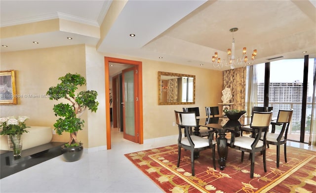 dining area with an inviting chandelier, ornamental molding, and a raised ceiling