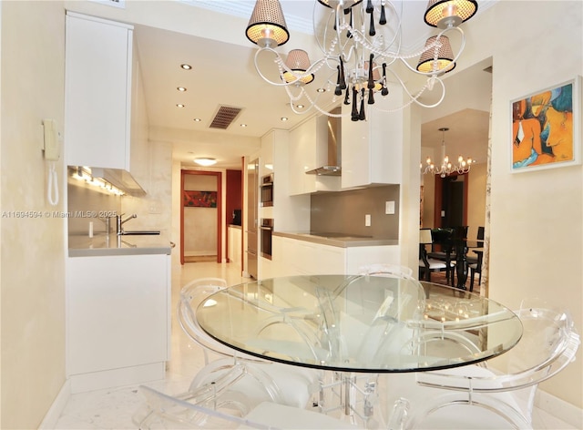 dining space featuring sink and a notable chandelier