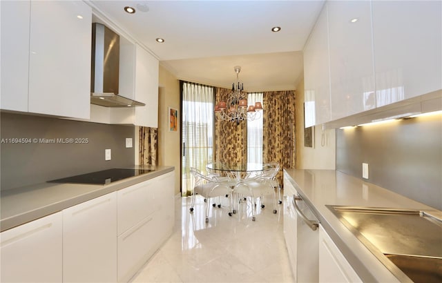 kitchen with dishwasher, white cabinets, black electric cooktop, decorative light fixtures, and wall chimney exhaust hood