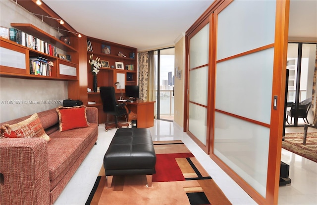 office space featuring floor to ceiling windows and built in desk