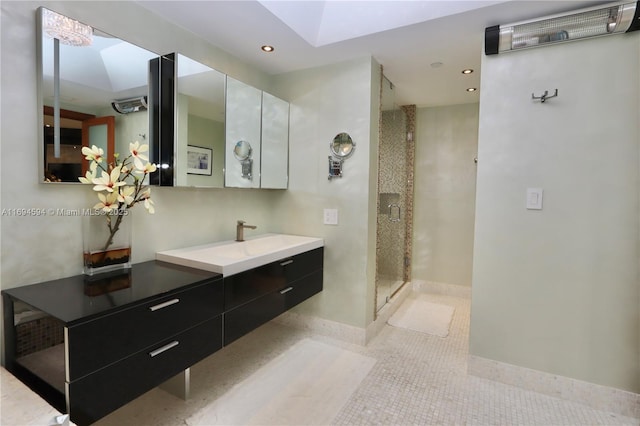 bathroom with vanity, tile patterned flooring, a skylight, and tiled shower