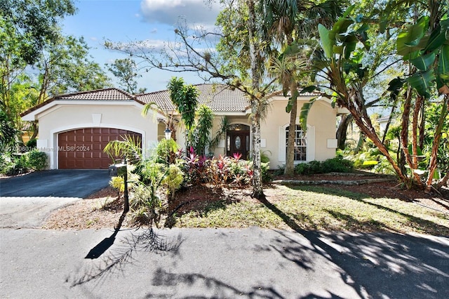 mediterranean / spanish house with a garage