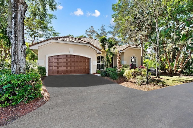 mediterranean / spanish-style home with a garage