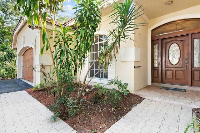 view of exterior entry with a garage