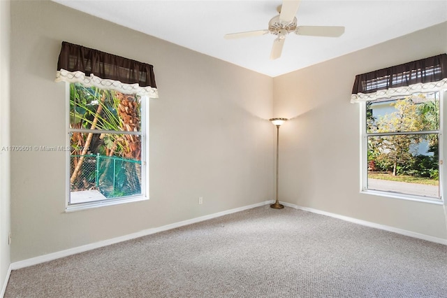 carpeted spare room featuring ceiling fan