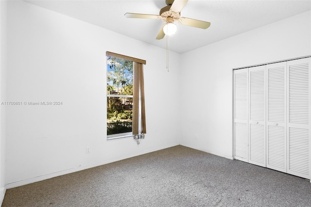 unfurnished bedroom featuring carpet flooring, a closet, and ceiling fan