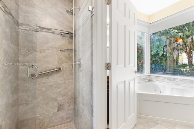 bathroom featuring tile patterned floors and shower with separate bathtub