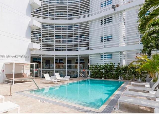 view of swimming pool featuring a patio area