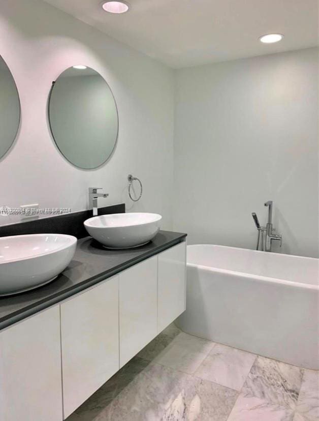 bathroom with vanity and a tub to relax in