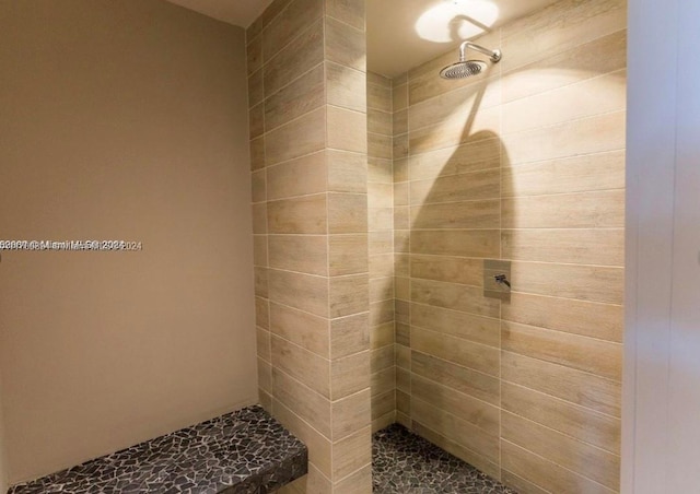 bathroom with tiled shower